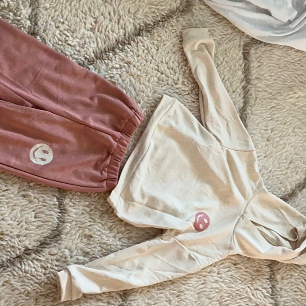 Pink pant and white top with smiley face in the front